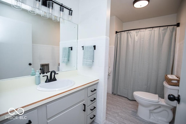 8310 N County Road 700 W, Scipio, IN 47273 - full bath with tile walls, wood finished floors, vanity, a wainscoted wall, and a shower with shower curtain