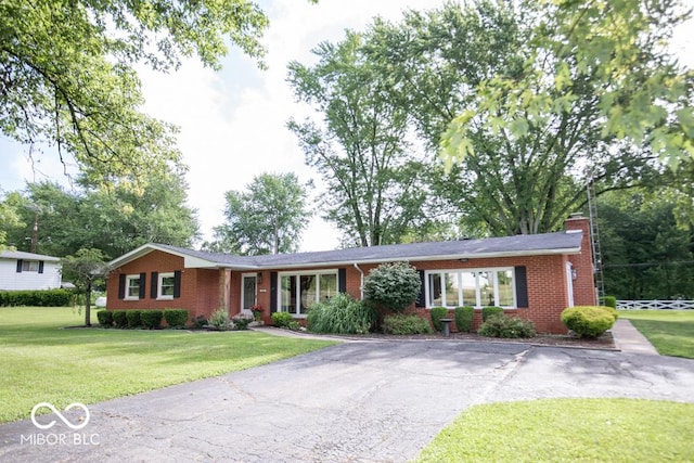 8310 N County Road 700 W, Scipio, IN 47273 - single story home with a front yard, brick siding, driveway, and a chimney