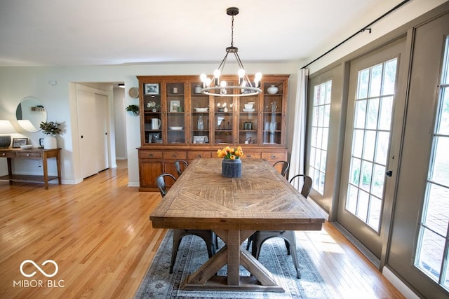 8310 N County Road 700 W, Scipio, IN 47273 - dining area with a chandelier, plenty of natural light, and light wood-type flooring