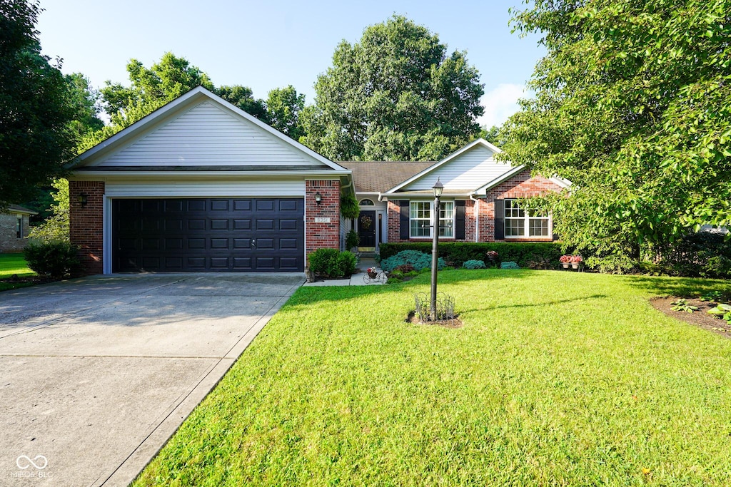 6351 Barberry Dr, Avon, IN 46123 - single story home with brick siding, driveway, a front yard, and a garage
