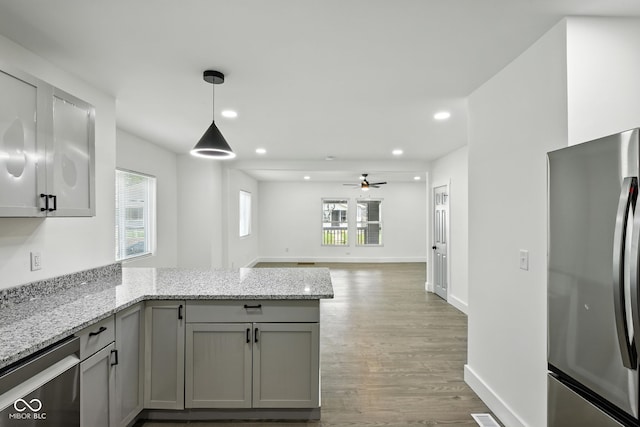 2000 N Dexter St, Indianapolis, IN 46202 - kitchen with a peninsula, appliances with stainless steel finishes, gray cabinets, ceiling fan, and light wood-style flooring