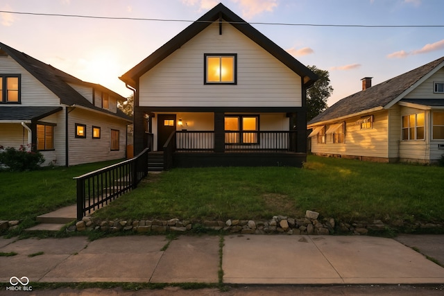2000 N Dexter St, Indianapolis, IN 46202 - back of property at dusk featuring covered porch and a lawn