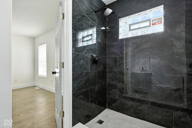 2000 N Dexter St, Indianapolis, IN 46202 - bathroom featuring plenty of natural light, wood finished floors, and tiled shower