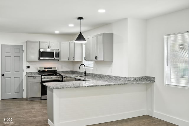 2000 N Dexter St, Indianapolis, IN 46202 - kitchen with stainless steel appliances, dark wood-style flooring, plenty of natural light, light stone counters, and recessed lighting