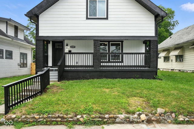 2000 N Dexter St, Indianapolis, IN 46202 - view of front facade featuring a porch, a front yard, and brick siding