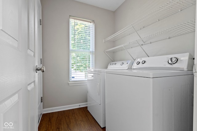 11426 High Grass Dr, Indianapolis, IN 46235 - laundry area featuring washing machine and dryer, plenty of natural light, and dark wood finished floors