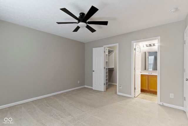 11426 High Grass Dr, Indianapolis, IN 46235 - unfurnished bedroom with light carpet, a spacious closet, ensuite bathroom, and a ceiling fan