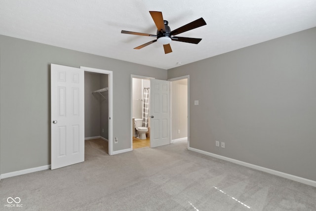 11426 High Grass Dr, Indianapolis, IN 46235 - unfurnished bedroom featuring a spacious closet, light carpet, connected bathroom, and ceiling fan