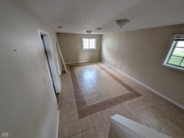 8454 Saxon Ct, Columbus, IN 47201 - unfurnished room featuring tile patterned flooring and a textured ceiling