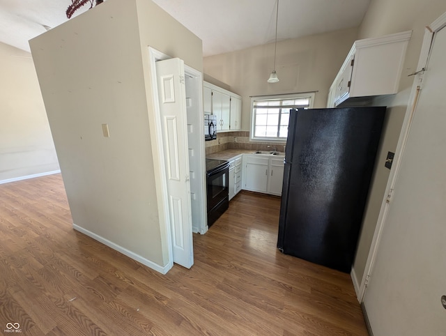8454 Saxon Ct, Columbus, IN 47201 - kitchen featuring black appliances, white cabinetry, dark wood-style floors, and backsplash