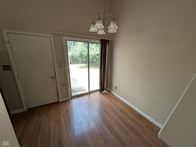 8454 Saxon Ct, Columbus, IN 47201 - unfurnished dining area with a chandelier and wood finished floors