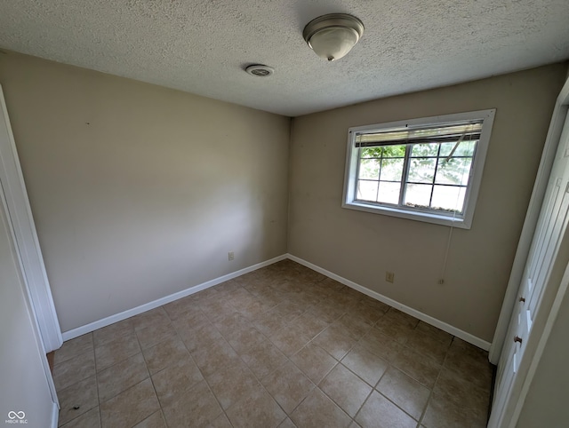 8454 Saxon Ct, Columbus, IN 47201 - spare room featuring a textured ceiling and tile patterned flooring