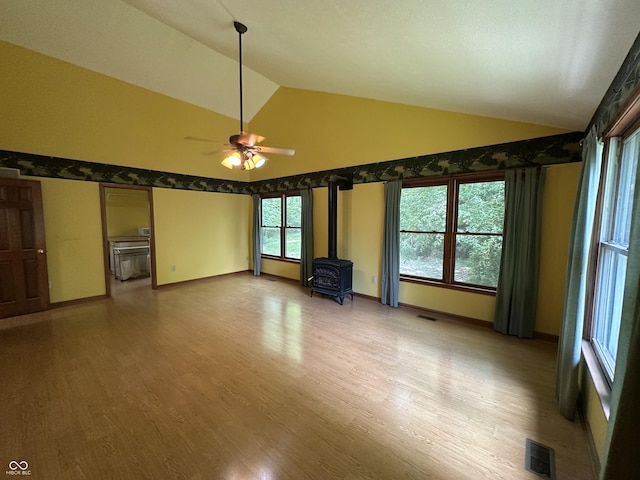 2765 S 1200 E, Zionsville, IN 46077 - unfurnished living room with a wood stove, ceiling fan, light wood-type flooring, and high vaulted ceiling
