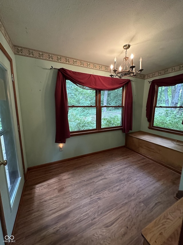 2765 S 1200 E, Zionsville, IN 46077 - empty room with a chandelier, plenty of natural light, wood finished floors, and a textured ceiling