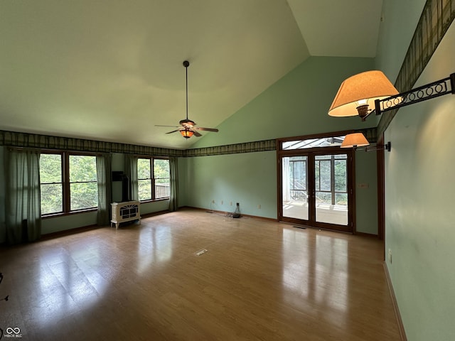 2765 S 1200 E, Zionsville, IN 46077 - unfurnished living room with high vaulted ceiling, a ceiling fan, a wood stove, and wood finished floors