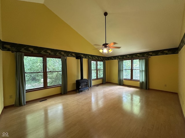 2765 S 1200 E, Zionsville, IN 46077 - empty room featuring a wood stove, ceiling fan, high vaulted ceiling, and light wood-type flooring