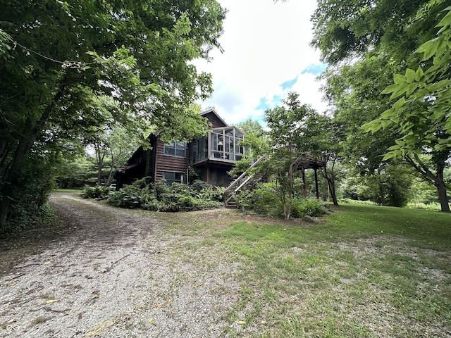 2765 S 1200 E, Zionsville, IN 46077 - view of home's exterior featuring stairway, a sunroom, a lawn, driveway, and a wooden deck