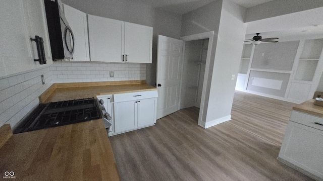 1805 S Denny St, Indianapolis, IN 46203 - kitchen featuring wood finished floors, a ceiling fan, white cabinets, decorative backsplash, and built in features