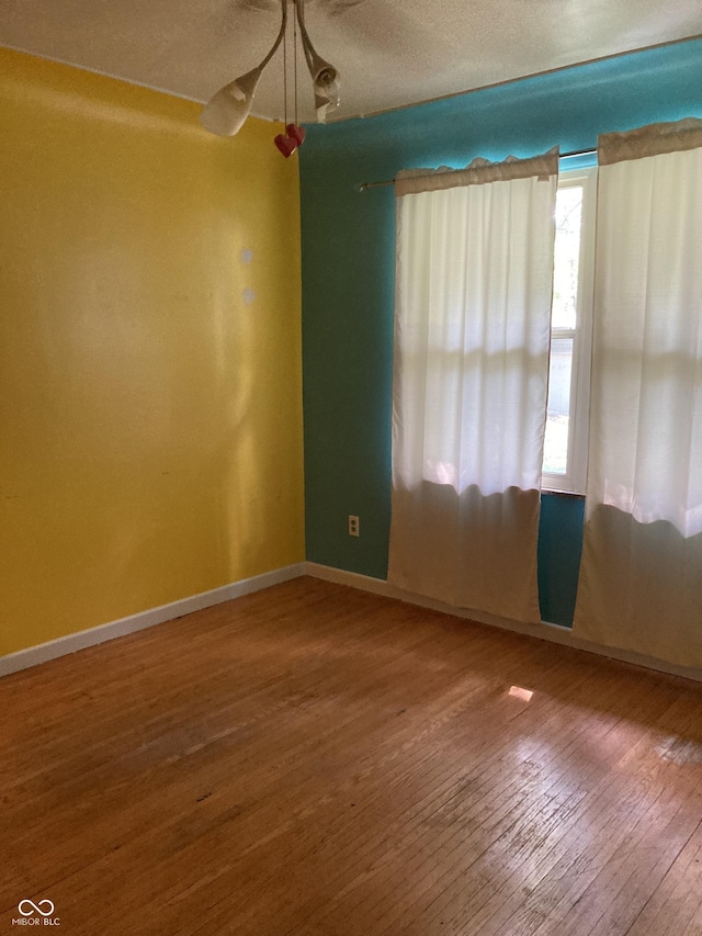 1016 N Mitchner Ave, Indianapolis, IN 46219 - empty room featuring hardwood / wood-style floors and ceiling fan