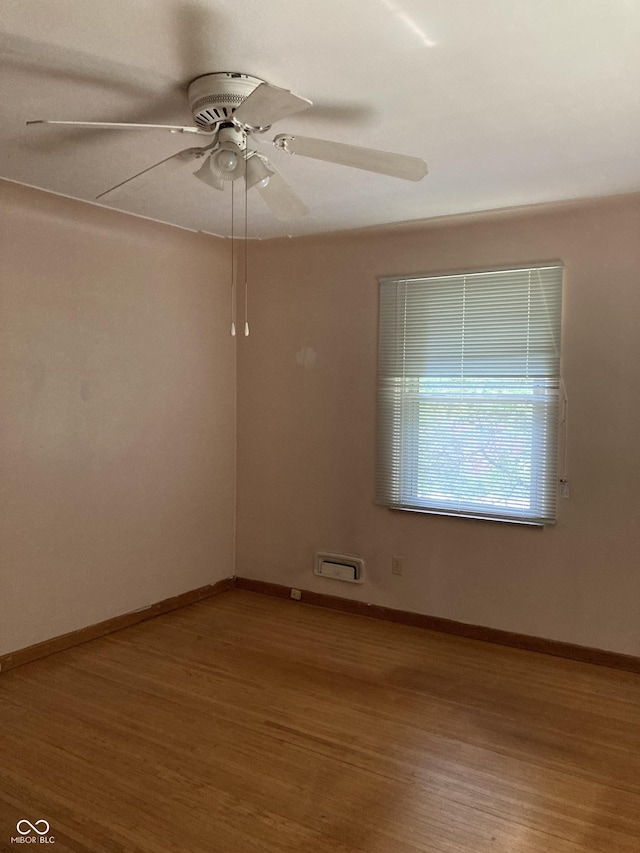 1016 N Mitchner Ave, Indianapolis, IN 46219 - empty room with wood finished floors and ceiling fan