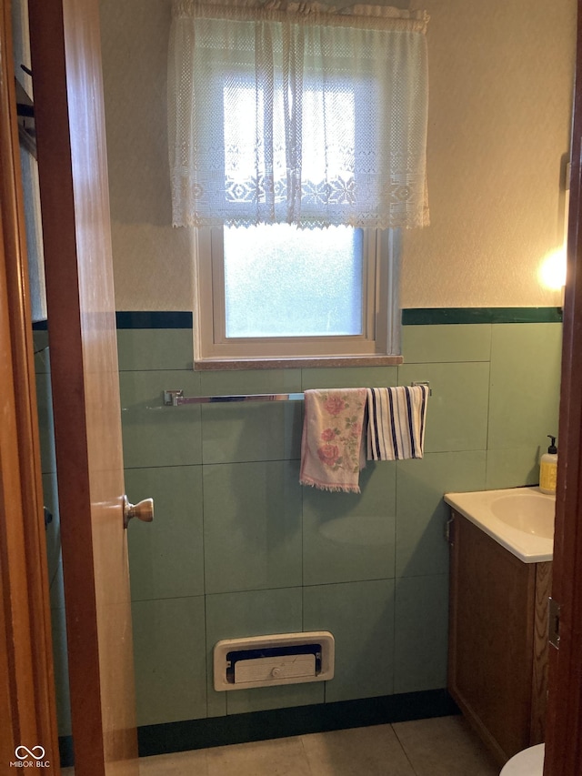 1016 N Mitchner Ave, Indianapolis, IN 46219 - half bath with vanity, tile walls, tile patterned flooring, and wainscoting