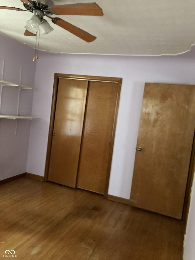 1016 N Mitchner Ave, Indianapolis, IN 46219 - unfurnished bedroom featuring wood finished floors, a closet, and a ceiling fan