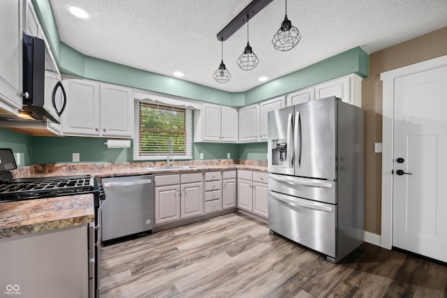 173 W Lakeview Dr, Nineveh, IN 46164 - kitchen with stainless steel appliances, light wood-style floors, a textured ceiling, white cabinetry, and recessed lighting