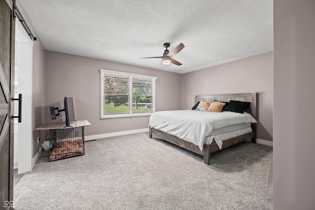 173 W Lakeview Dr, Nineveh, IN 46164 - bedroom featuring a barn door, carpet flooring, a textured ceiling, and ceiling fan