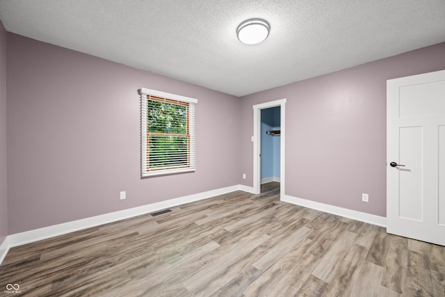 173 W Lakeview Dr, Nineveh, IN 46164 - unfurnished bedroom with wood finished floors, a textured ceiling, and a spacious closet