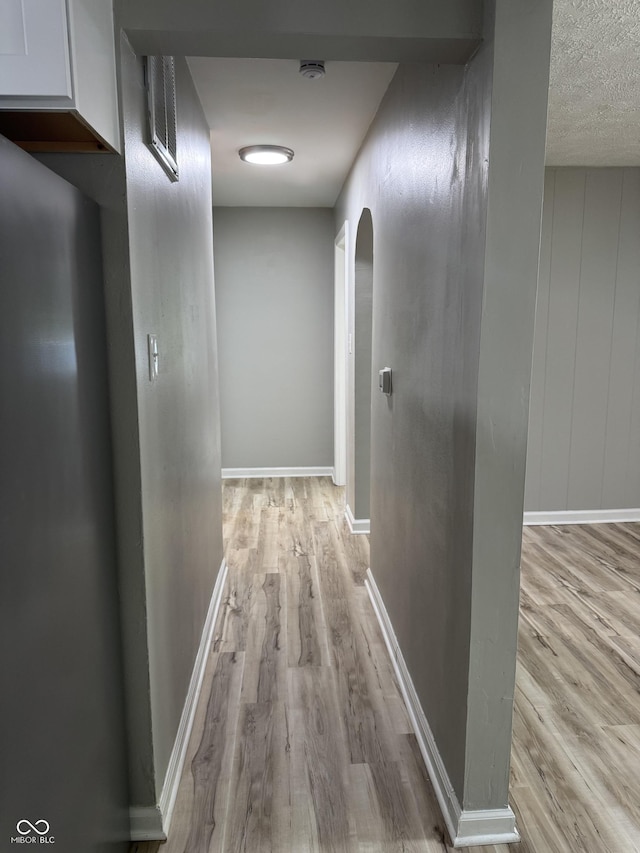 67 N Devon Ave, Indianapolis, IN 46219 - hall with arched walkways and light wood finished floors