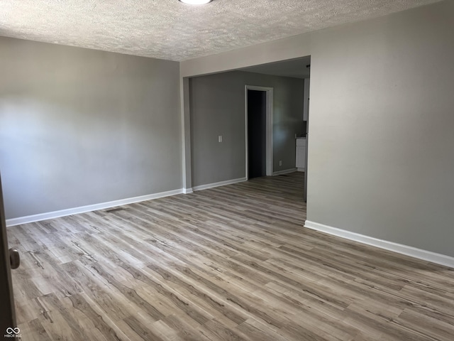 67 N Devon Ave, Indianapolis, IN 46219 - empty room with a textured ceiling and wood finished floors