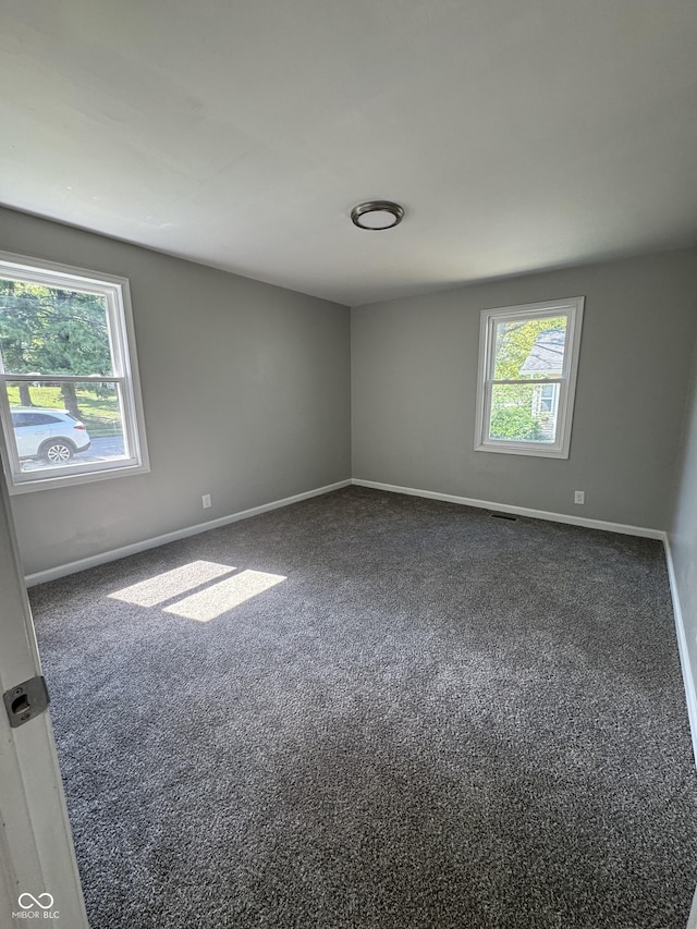 67 N Devon Ave, Indianapolis, IN 46219 - spare room with baseboards and carpet flooring