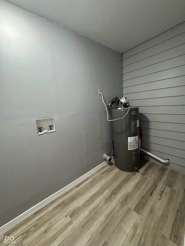 67 N Devon Ave, Indianapolis, IN 46219 - laundry view of electric water heater and wood finished floors