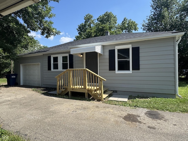 67 N Devon Ave, Indianapolis, IN 46219 - view of front of home with driveway, roof with shingles, and a garage