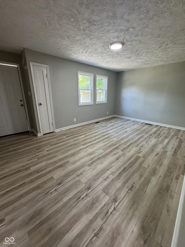 67 N Devon Ave, Indianapolis, IN 46219 - empty room with a textured ceiling and wood finished floors