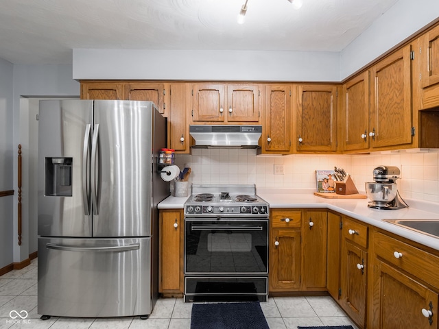 479 Raintree Dr, Danville, IN 46122 - kitchen featuring stainless steel refrigerator with ice dispenser, range with electric stovetop, under cabinet range hood, light countertops, and brown cabinets