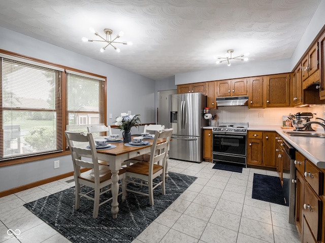 479 Raintree Dr, Danville, IN 46122 - kitchen featuring electric range oven, stainless steel fridge with ice dispenser, under cabinet range hood, a chandelier, and brown cabinetry