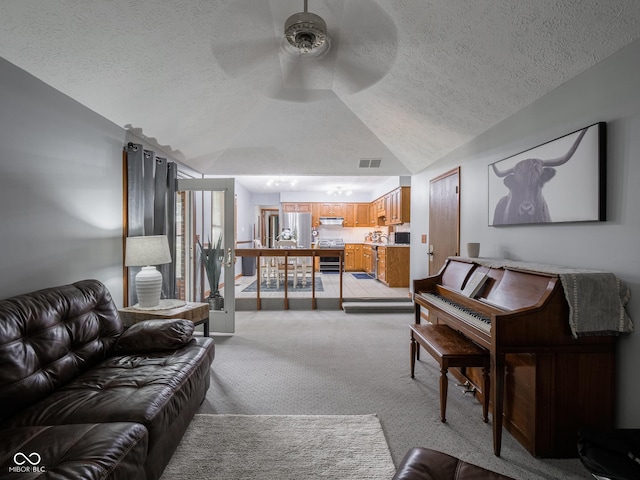 479 Raintree Dr, Danville, IN 46122 - living area with a textured ceiling, lofted ceiling, a ceiling fan, and light colored carpet