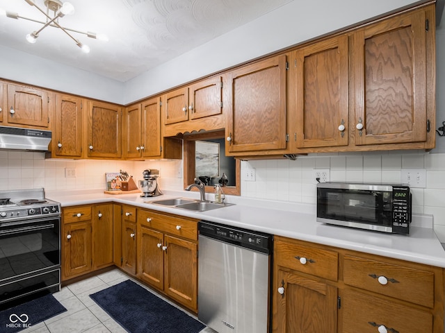 479 Raintree Dr, Danville, IN 46122 - kitchen featuring appliances with stainless steel finishes, under cabinet range hood, brown cabinetry, light countertops, and tasteful backsplash
