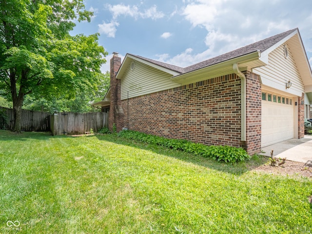 479 Raintree Dr, Danville, IN 46122 - view of side of property featuring brick siding, a garage, driveway, and a chimney