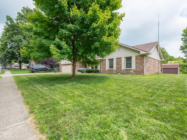 479 Raintree Dr, Danville, IN 46122 - view of front of house featuring brick siding, a front lawn, and a garage