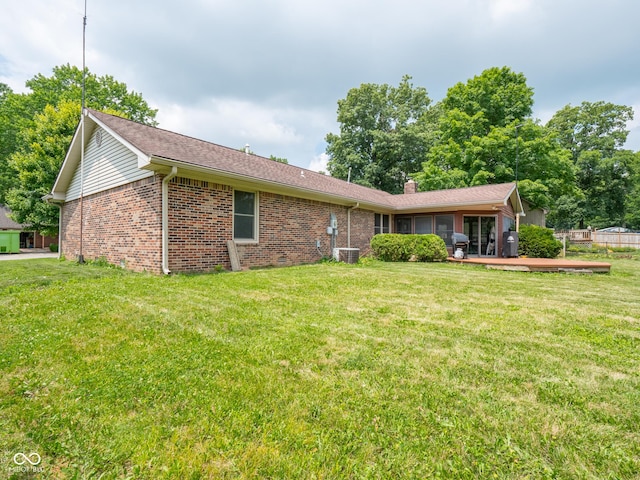 479 Raintree Dr, Danville, IN 46122 - rear view of property featuring brick siding, a lawn, a wooden deck, and a chimney