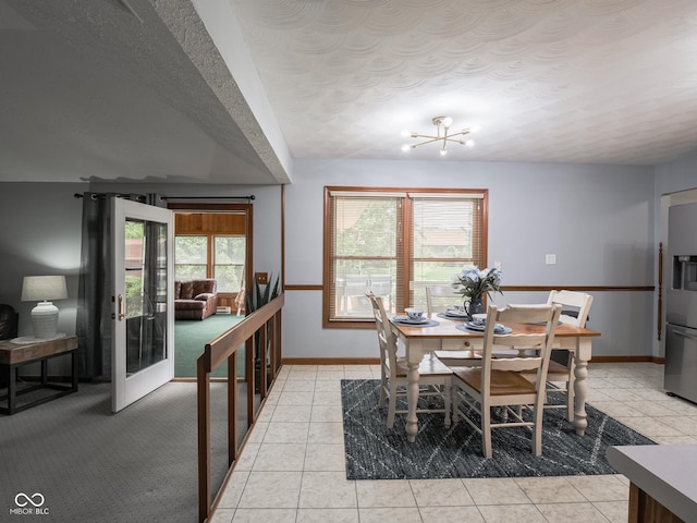 479 Raintree Dr, Danville, IN 46122 - dining space featuring a chandelier, a textured ceiling, and light tile patterned floors