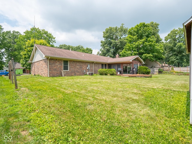 479 Raintree Dr, Danville, IN 46122 - rear view of property featuring brick siding and a chimney