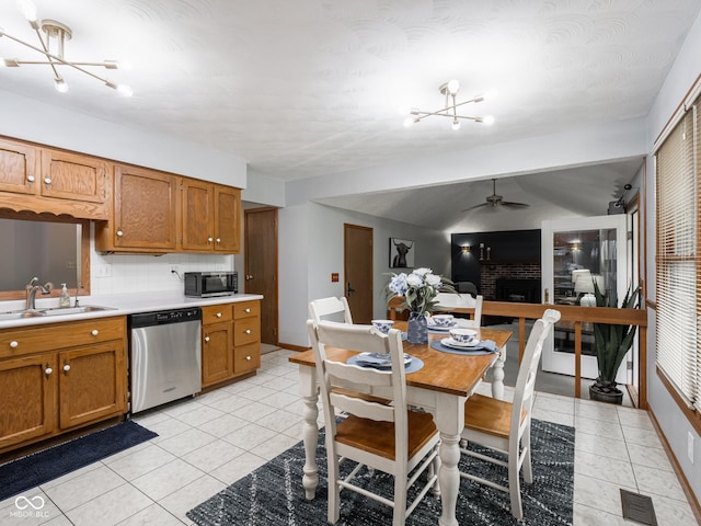 479 Raintree Dr, Danville, IN 46122 - kitchen with stainless steel appliances, ceiling fan, brown cabinetry, light countertops, and light tile patterned flooring