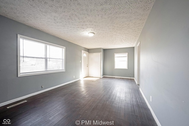 5737 E 22nd St, Indianapolis, IN 46218 - spare room with dark wood finished floors and a textured ceiling