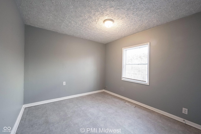 5737 E 22nd St, Indianapolis, IN 46218 - spare room with a textured ceiling and baseboards