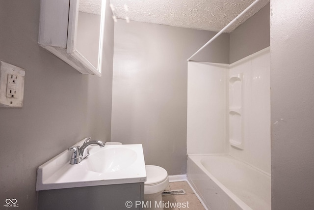 5737 E 22nd St, Indianapolis, IN 46218 - bathroom with vanity, a textured ceiling, washtub / shower combination, and tile patterned flooring