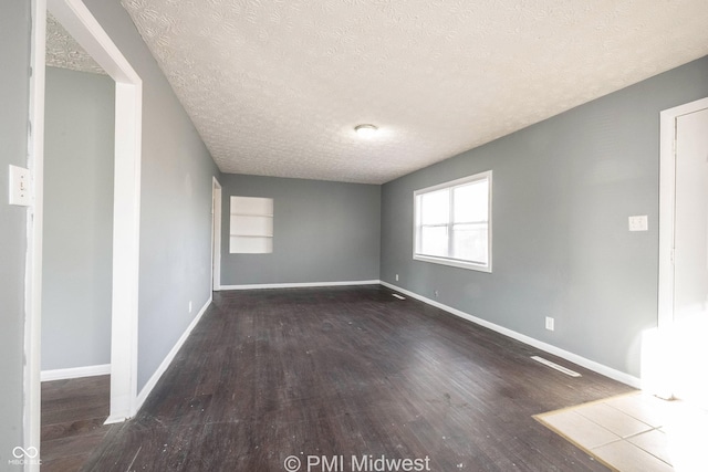5737 E 22nd St, Indianapolis, IN 46218 - spare room with a textured ceiling and wood finished floors