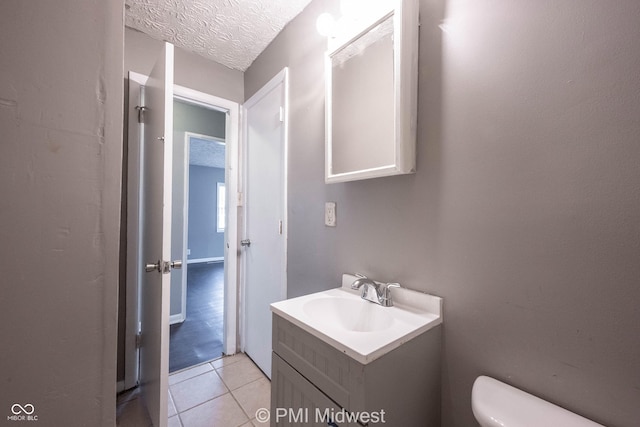 5737 E 22nd St, Indianapolis, IN 46218 - half bathroom with vanity, tile patterned flooring, and a textured ceiling